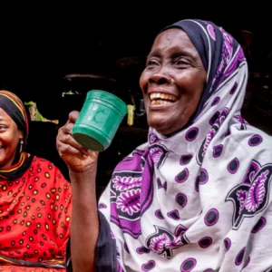 Two women holding mugs and smiling