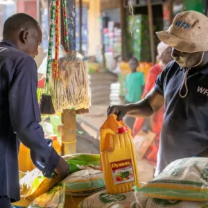 Mohamad Ibrahim, a local trader in Aweil, South Sudan, talks with Yai Kuan, WFP staff, in a market. The collection of food system data is increasingly at risk in many countries.