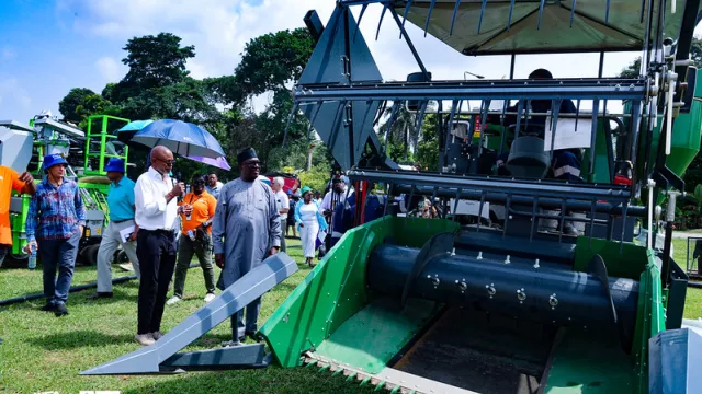 Alick Mulenga, Head of IITA Farm Management and Breeding Operations leading Dr Simeon Ehui and invited guests on a guided tour and demonstration of the irrigation facility and newly acquired farm machinery.
