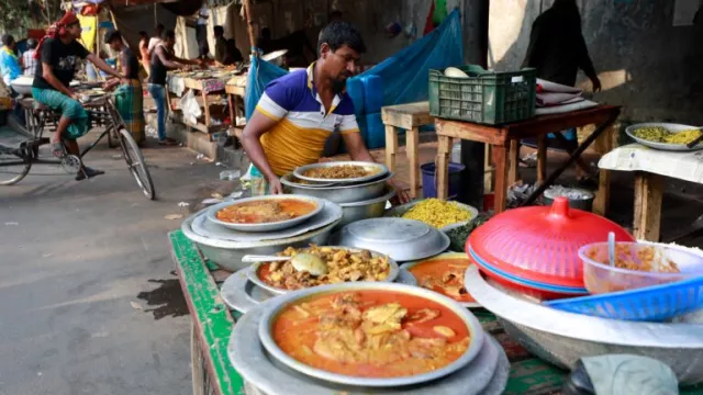 Vendors sell food on the sidewalk outside a hospital emergency room entrance in Dhaka, Bangladesh.